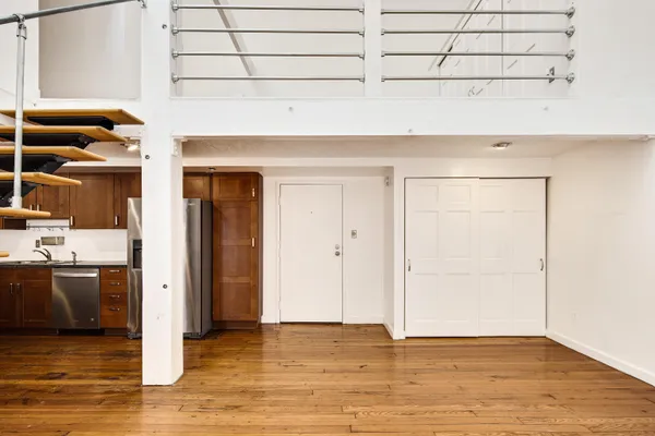 a view of an empty room and wooden floor
