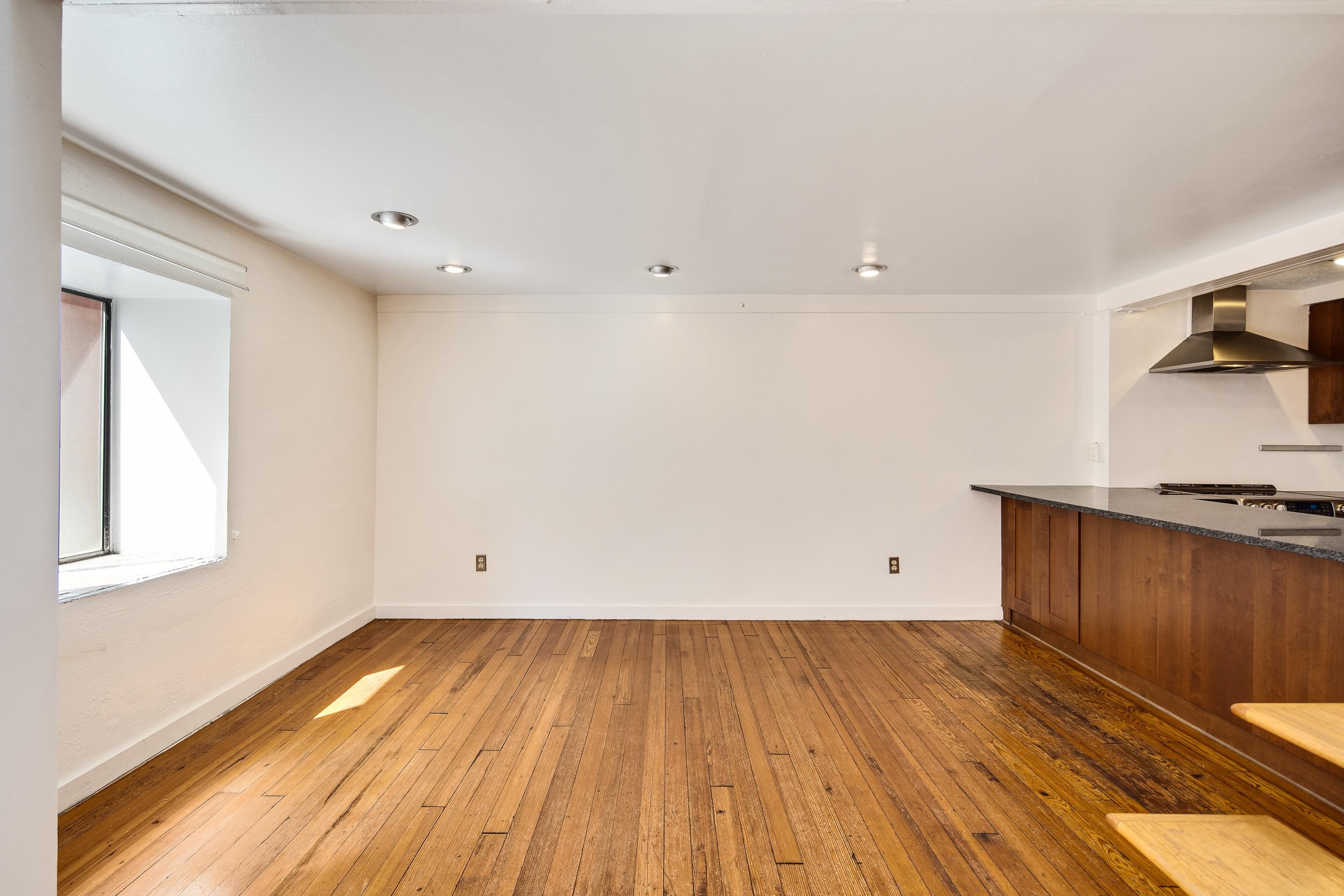 107 South Front Street, Unit 45 Memphis, TN 38103 - Photo 31 of 40 an empty room with wooden floor and cabinets