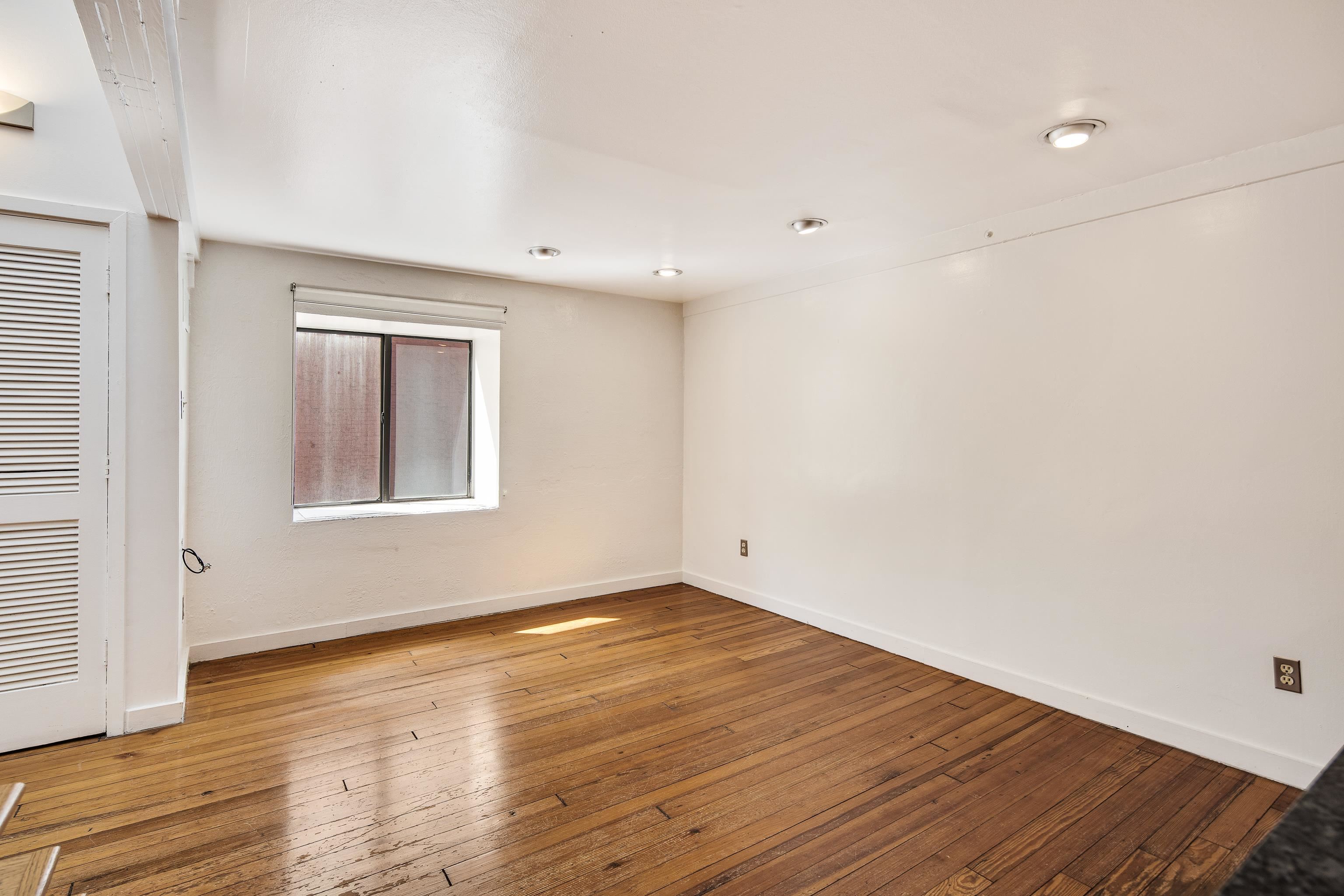 107 South Front Street, Unit 45 Memphis, TN 38103 - Photo 32 of 40 wooden floor in an empty room with a window