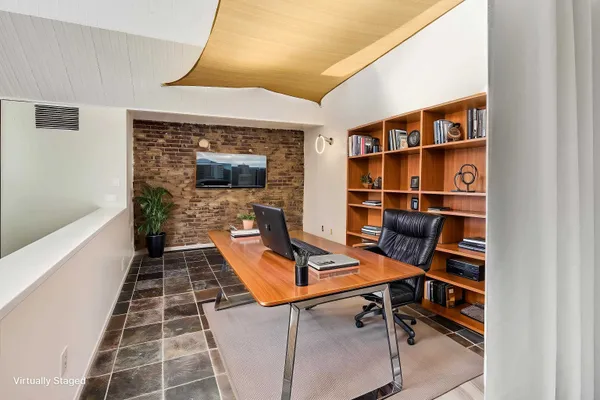 a view of a workspace with furniture