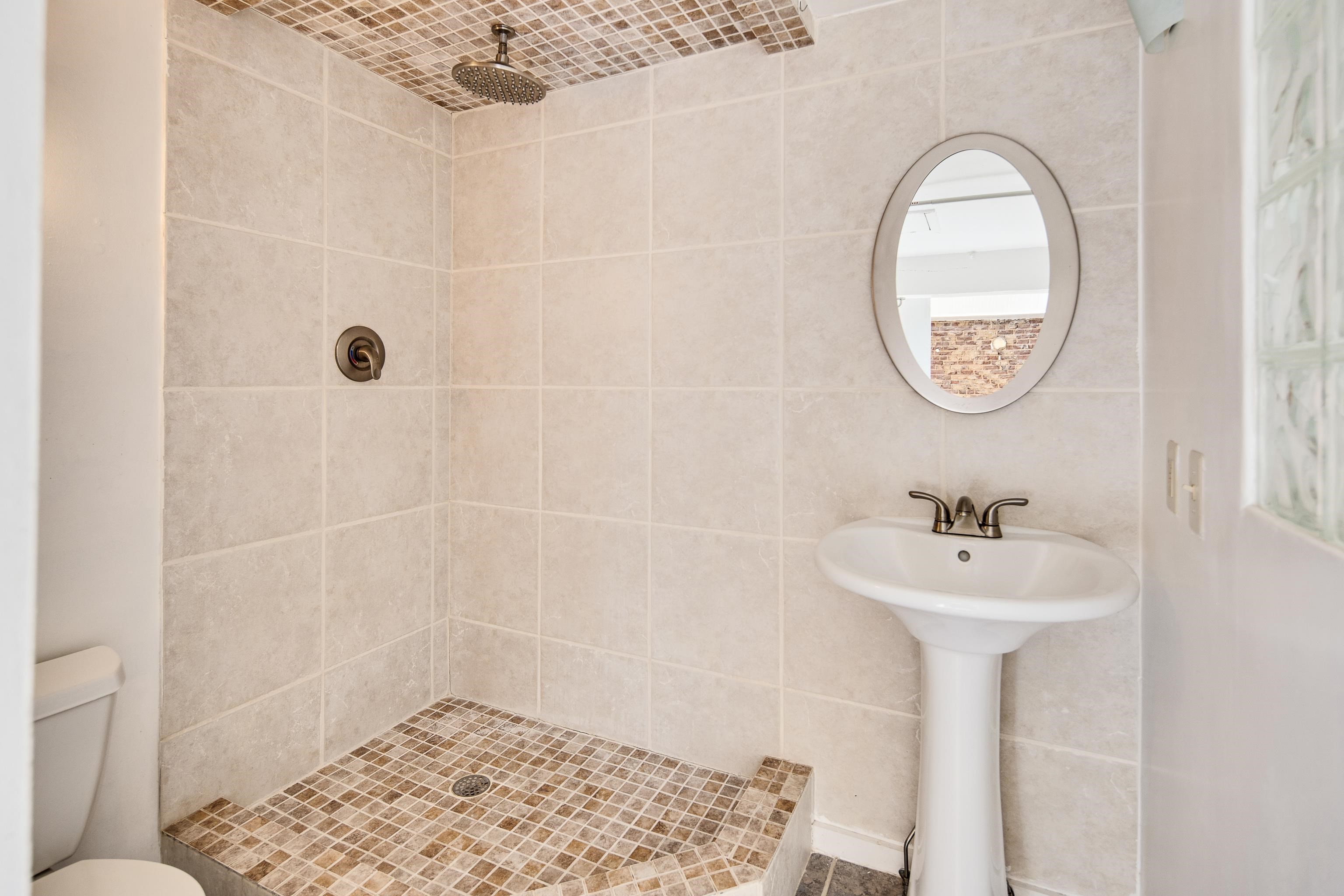 107 South Front Street, Unit 45 Memphis, TN 38103 - Photo 9 of 40 a bathroom with a sink a mirror and a shower
