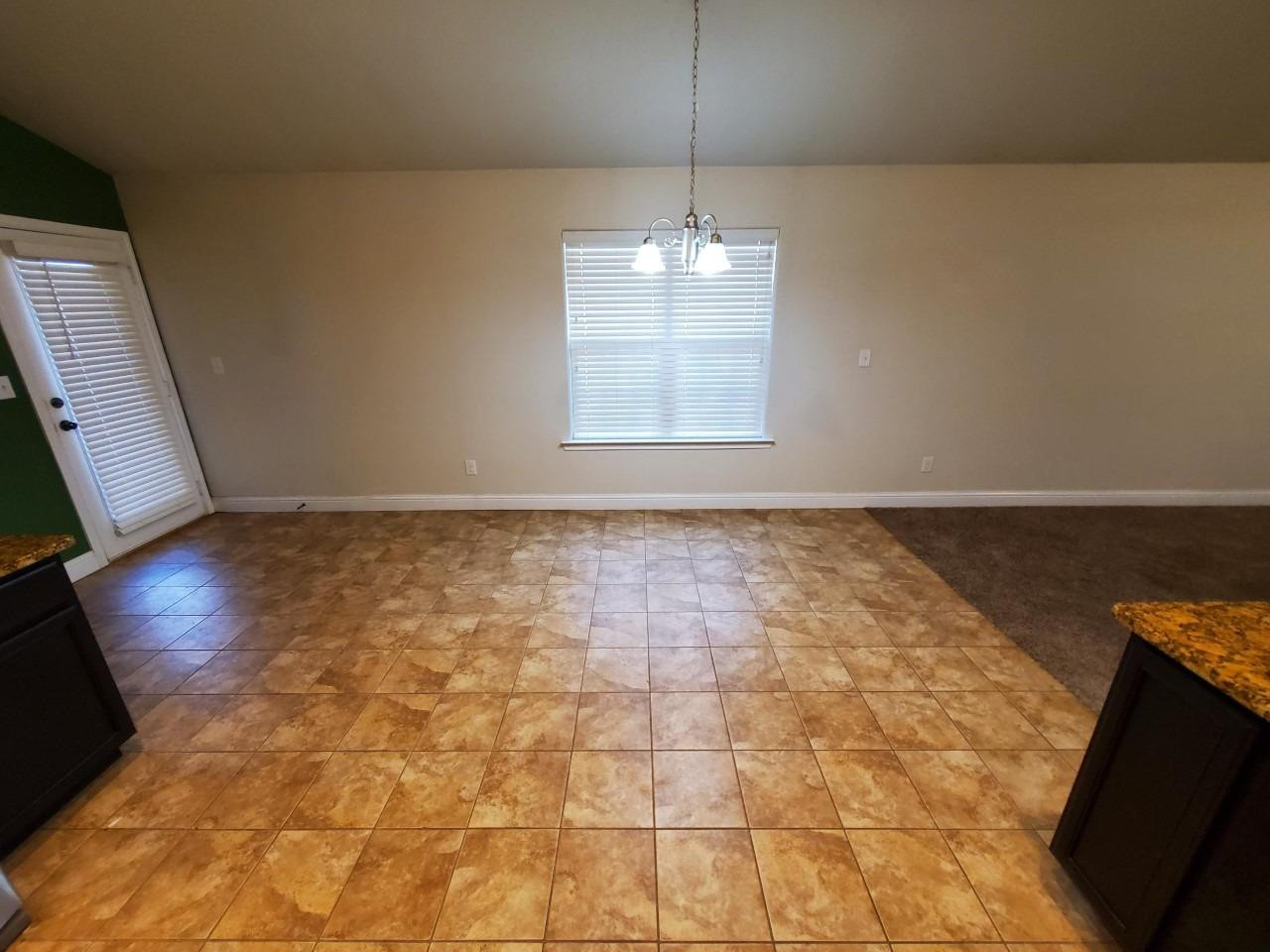 5602 111th Street Lubbock, TX 79424 - Photo 4 of 13 a view of livingroom with hardwood floor and kitchen