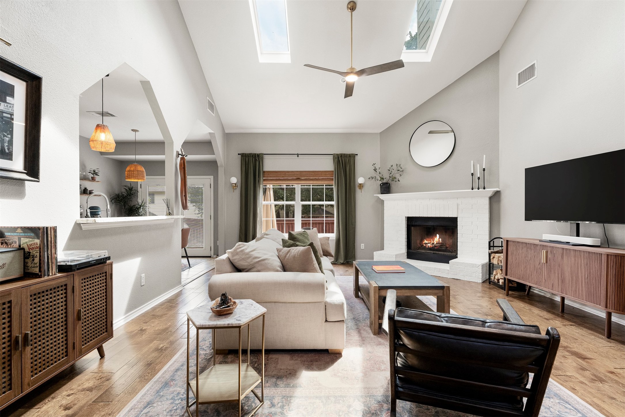 7009 Wandering Oak Road Austin, TX 78749 - Photo 1 of 36 High soaring ceilings and two Velux solar skylights draw abundant natural sunshine down into the central living area, creating an open and uplifting atmosphere for everyday living