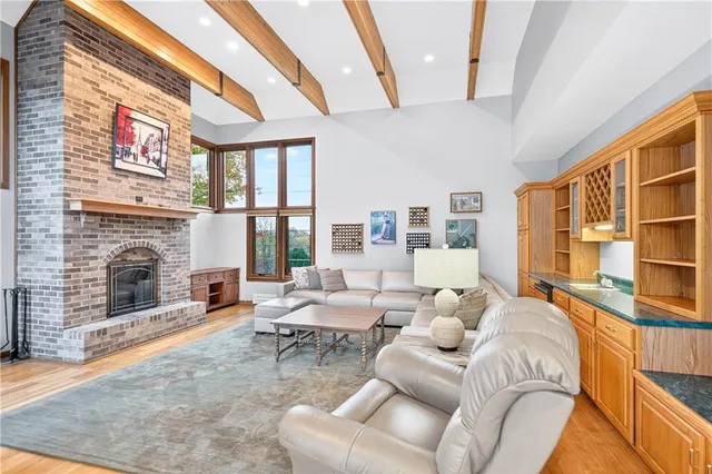 a living room with furniture large window and fireplace