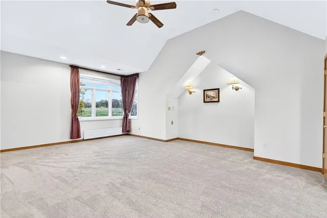 an empty room with fan and windows