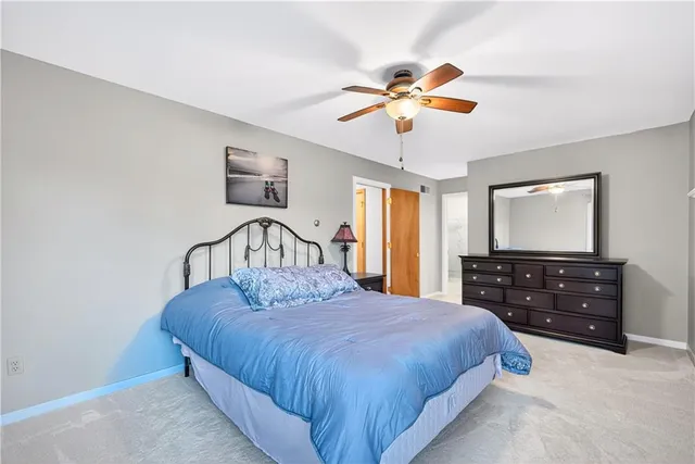 a bedroom with a large bed and a chandelier