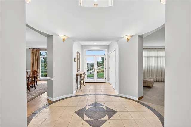 a view of a hallway with bathroom and glass door
