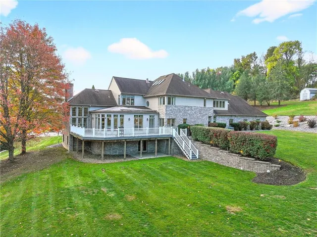 a view of a balcony with wooden floor and fence