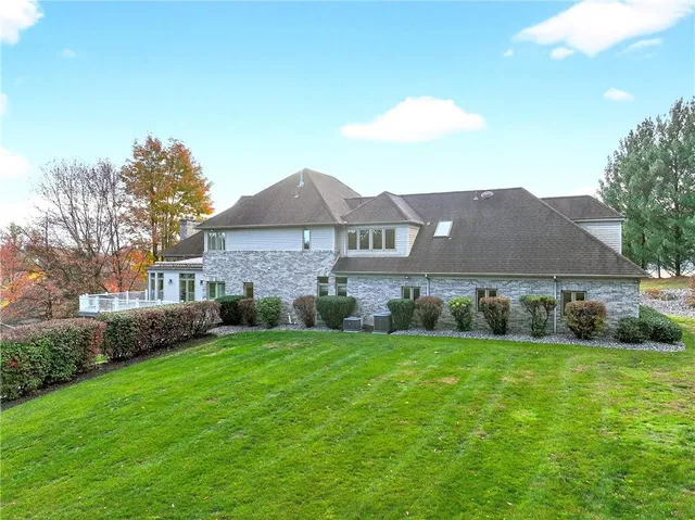 an aerial view of residential houses with outdoor space and trees