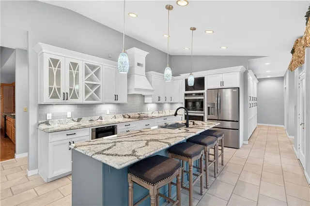 a kitchen that has a lot of cabinets in it and appliances