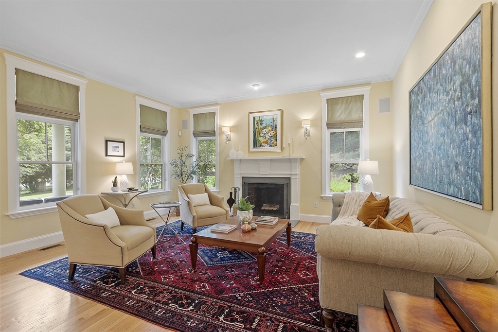 121 Concord Avenue Lexington, MA 02421 - Photo 11 of 42 a living room with furniture a rug and a fireplace