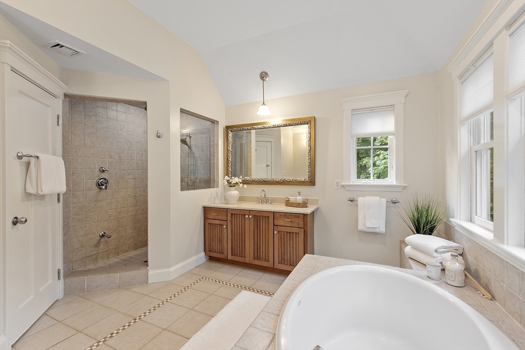 121 Concord Avenue Lexington, MA 02421 - Photo 19 of 42 a spacious bathroom with a granite countertop sink a toilet a mirror and shower