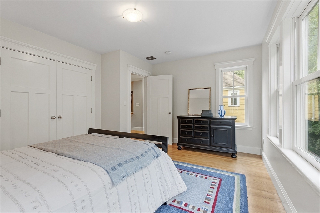 121 Concord Avenue Lexington, MA 02421 - Photo 23 of 42 a bedroom with a bed and wooden floor