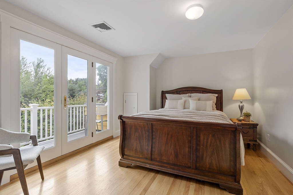 121 Concord Avenue Lexington, MA 02421 - Photo 24 of 42 a bedroom with a bed and wooden floor