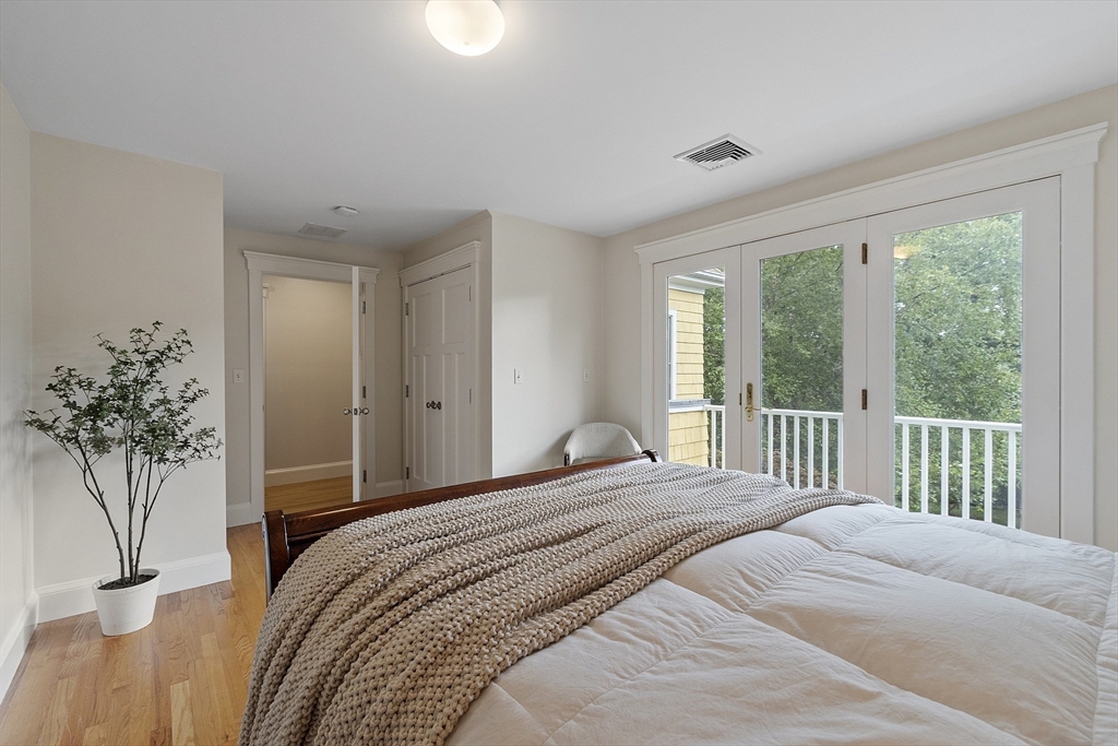 121 Concord Avenue Lexington, MA 02421 - Photo 25 of 42 a bedroom with a large bed and a potted plant