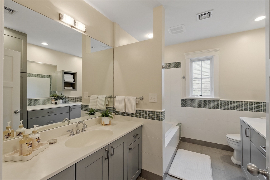 121 Concord Avenue Lexington, MA 02421 - Photo 26 of 42 a bathroom with a granite countertop double vanity sink and mirror