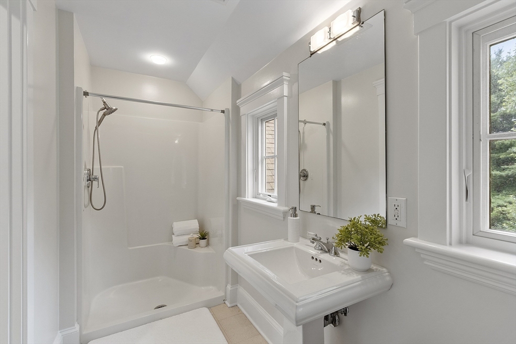 121 Concord Avenue Lexington, MA 02421 - Photo 27 of 42 a bathroom with a sink a shower and a mirror