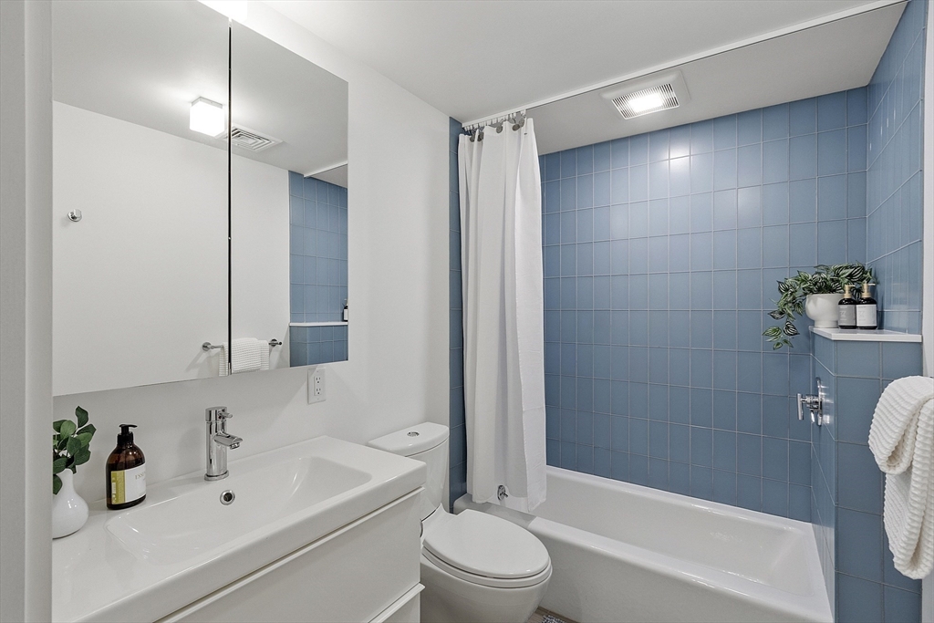 121 Concord Avenue Lexington, MA 02421 - Photo 34 of 42 a bathroom with a sink a toilet and shower