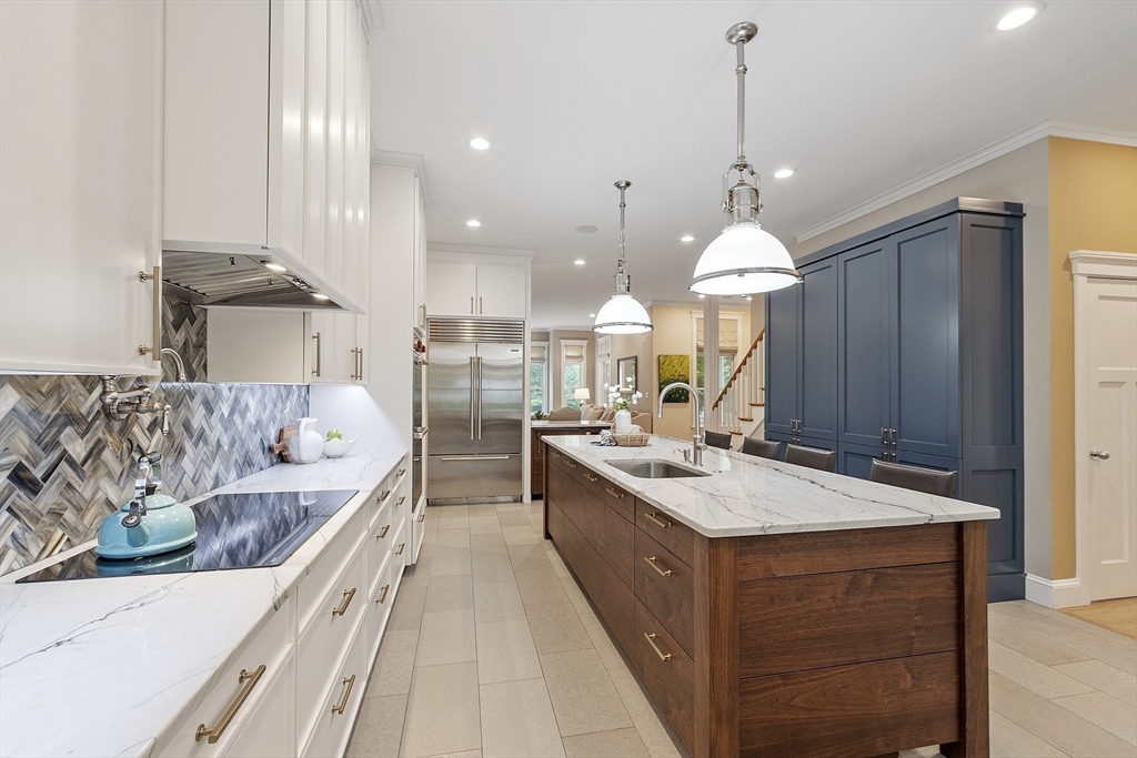 121 Concord Avenue Lexington, MA 02421 - Photo 4 of 42 a large kitchen with kitchen island a large island in it