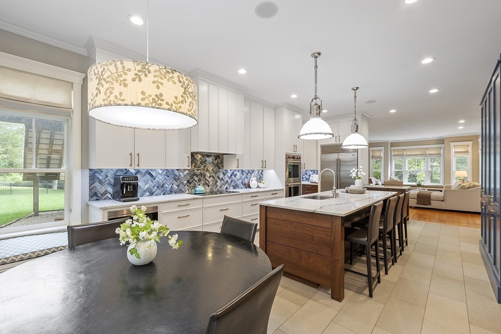 121 Concord Avenue Lexington, MA 02421 - Photo 5 of 42 a kitchen with a dining table and chairs