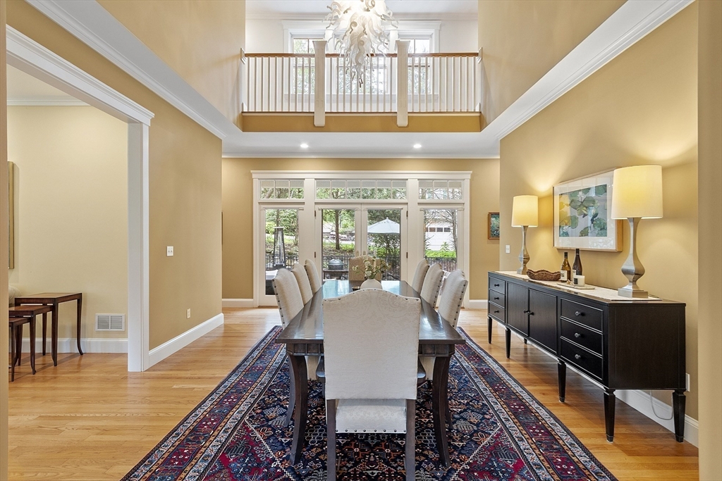 121 Concord Avenue Lexington, MA 02421 - Photo 9 of 42 a view of a dining room with furniture a chandelier and wooden floor