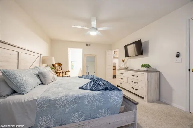 a spacious bedroom with a bed and window