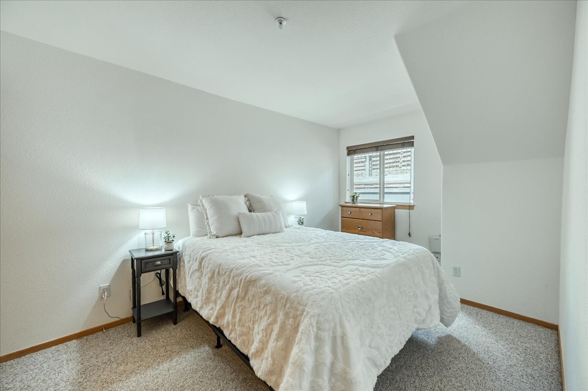 91399 Ryan Gulch Road, Unit B6 Silverthorne, CO 80498 - Photo 17 of 36 a bedroom with a bed and window