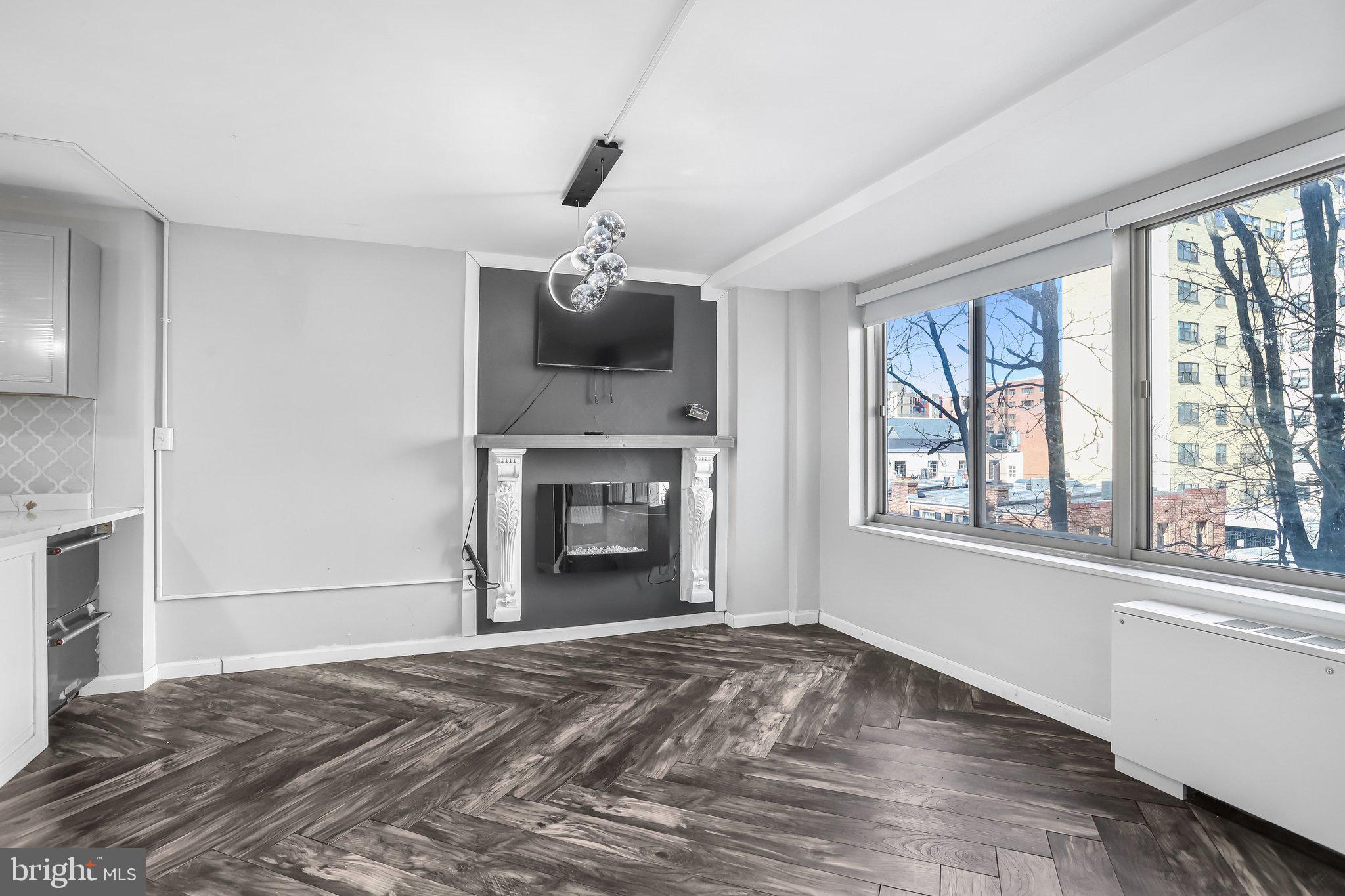 922 24th Street Northwest, Unit 301 Washington, DC 20037 - Photo 23 of 40 a view of an empty room with a window and fireplace