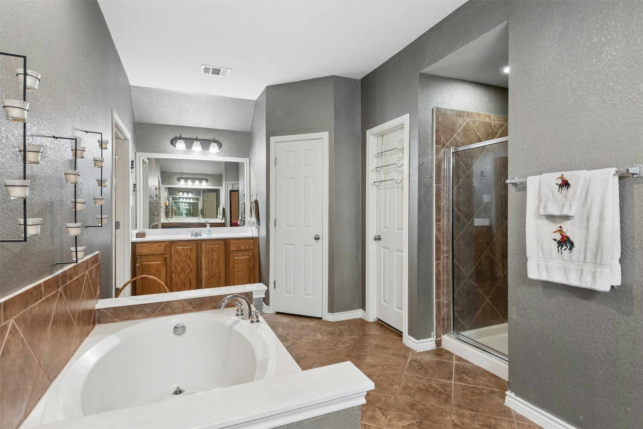 30013 Edgewood Drive Georgetown, TX 78628 - Photo 20 of 39 The Primary Bathroom also features 2 separate walk-in closets and double doors at both ends of the room to provide added privacy to the Bathroom