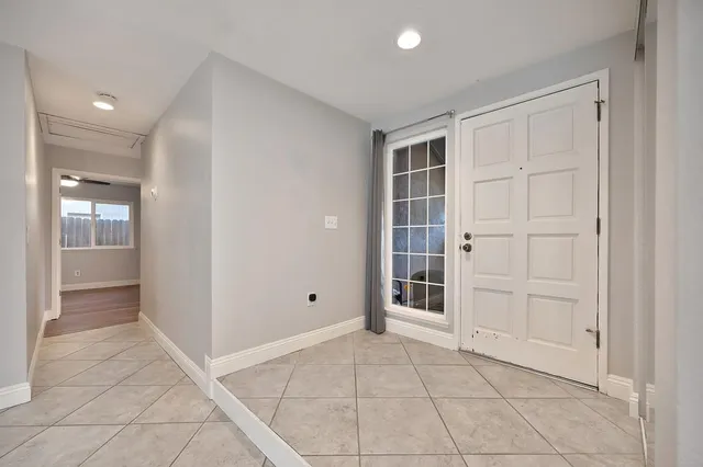 an empty room with cabinet and mirrors