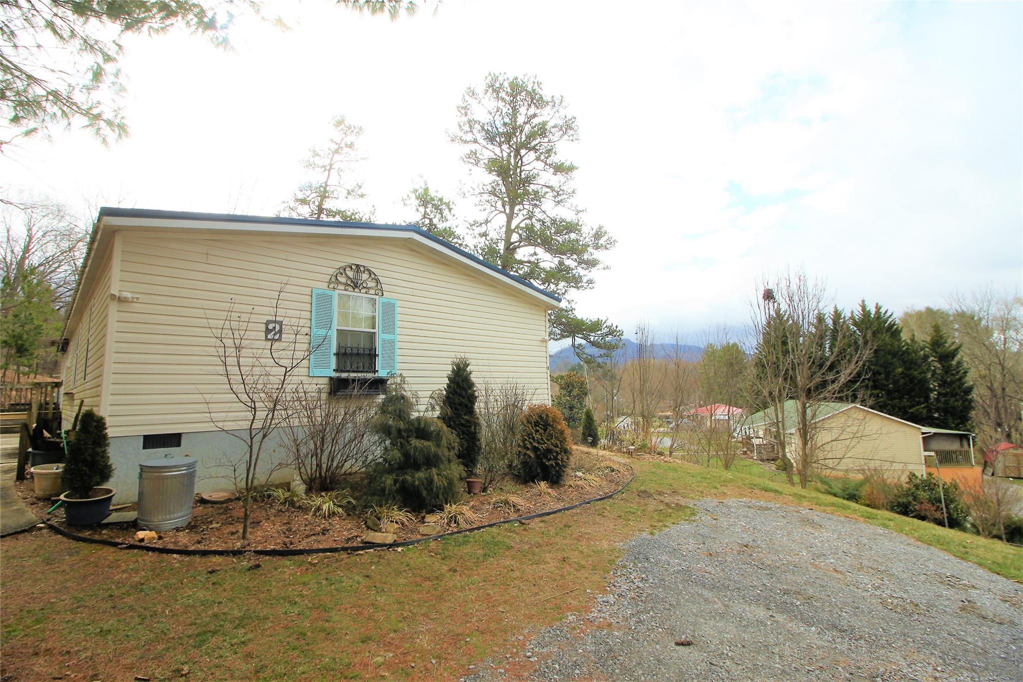 a view of a house with a backyard