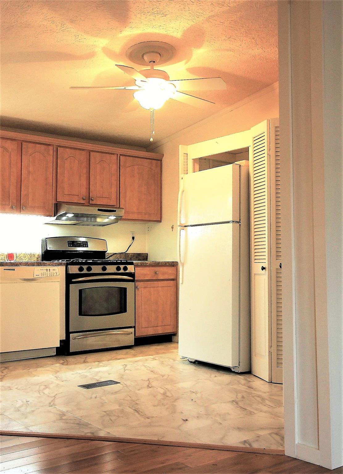 2 Whisper Street Clyde, NC 28721 - Photo 11 of 44 a kitchen with a refrigerator stove and a sink