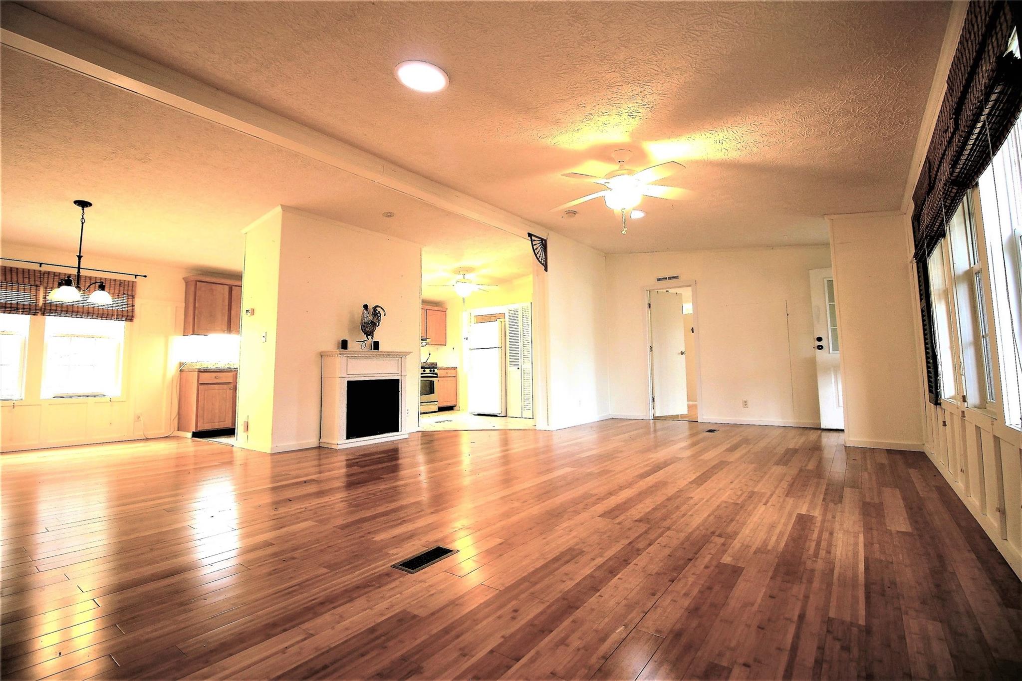 2 Whisper Street Clyde, NC 28721 - Photo 16 of 44 a view of a livingroom with wooden floor and a fireplace