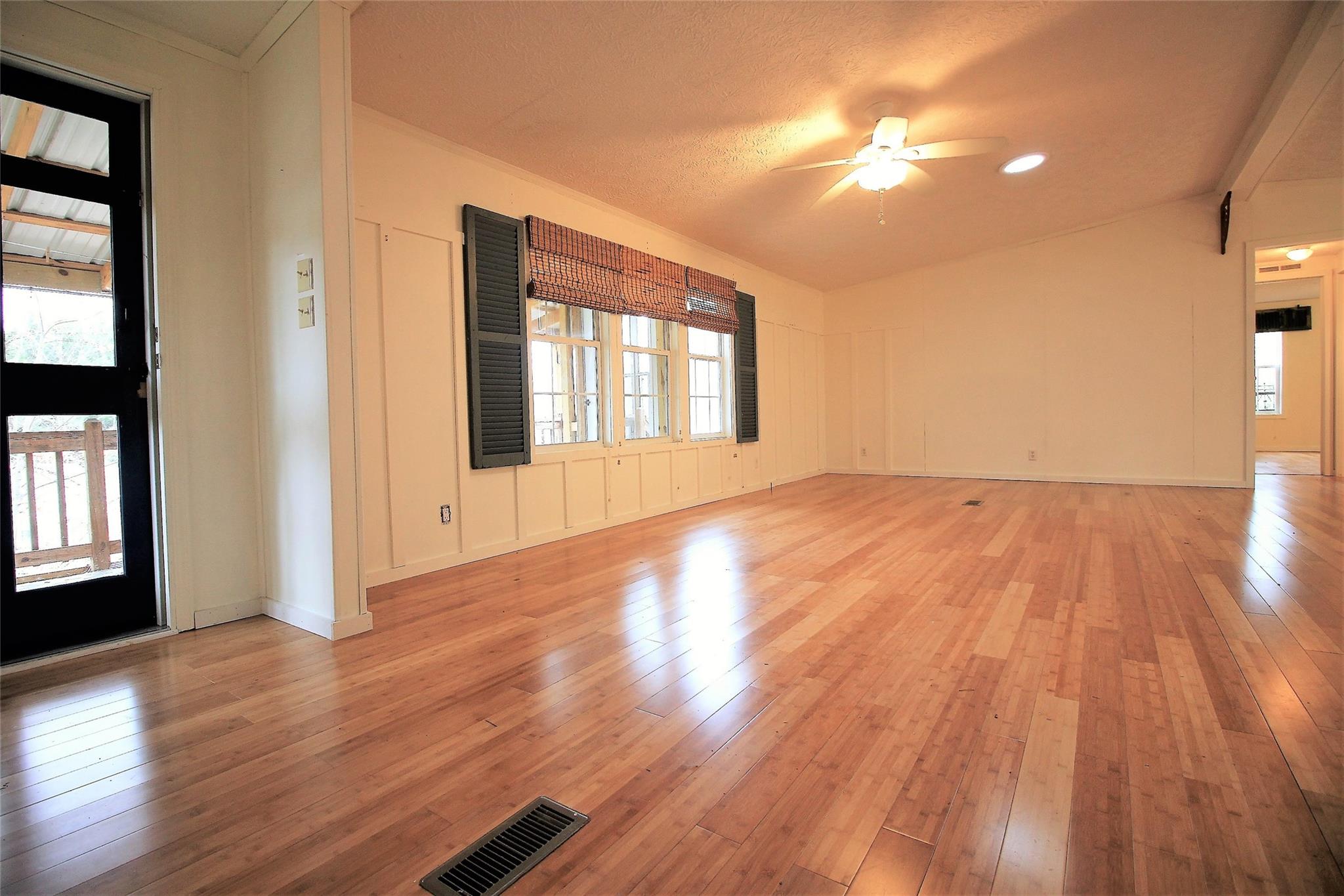 2 Whisper Street Clyde, NC 28721 - Photo 17 of 44 a view of an empty room with wooden floor and a window