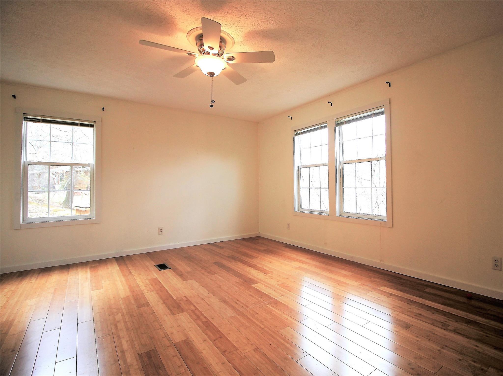 2 Whisper Street Clyde, NC 28721 - Photo 21 of 44 an empty room with wooden floor and windows