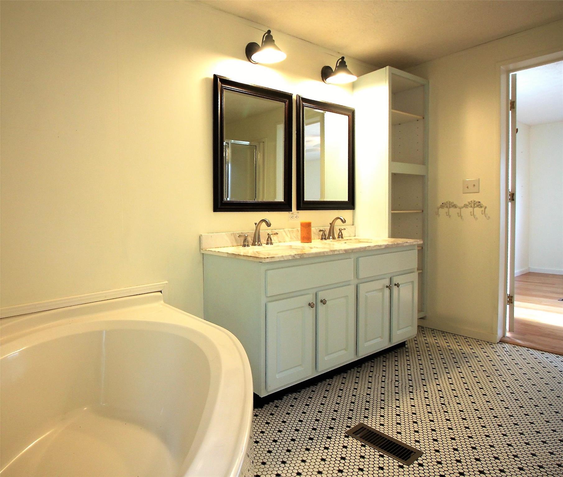 2 Whisper Street Clyde, NC 28721 - Photo 24 of 44 a spacious bathroom with a tub sink and mirror