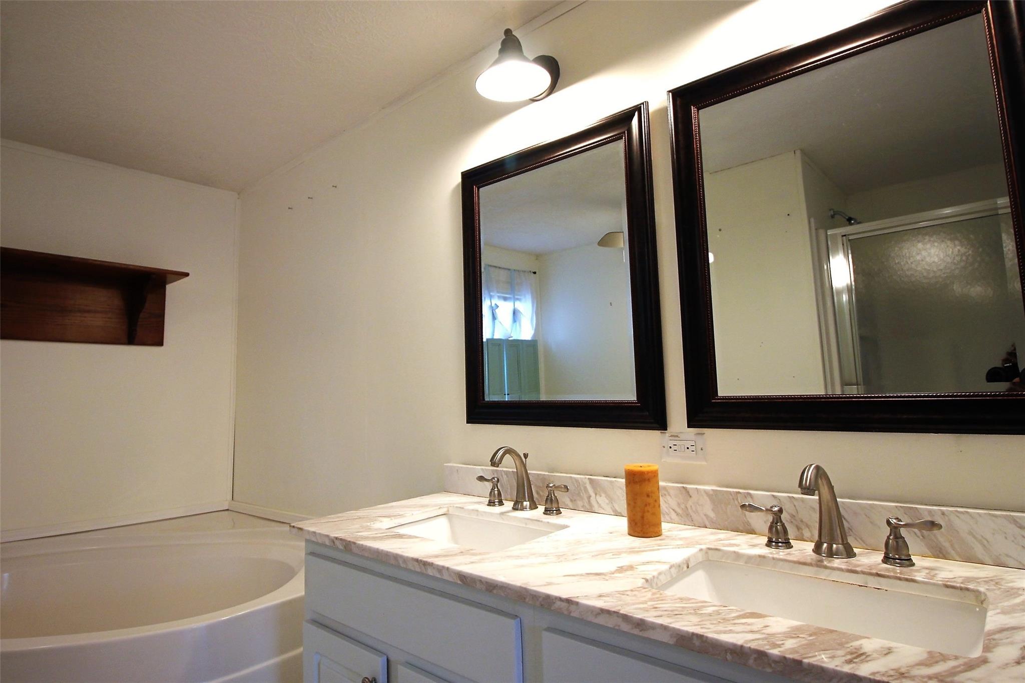 2 Whisper Street Clyde, NC 28721 - Photo 26 of 44 a bathroom with a granite countertop tub sink and mirror