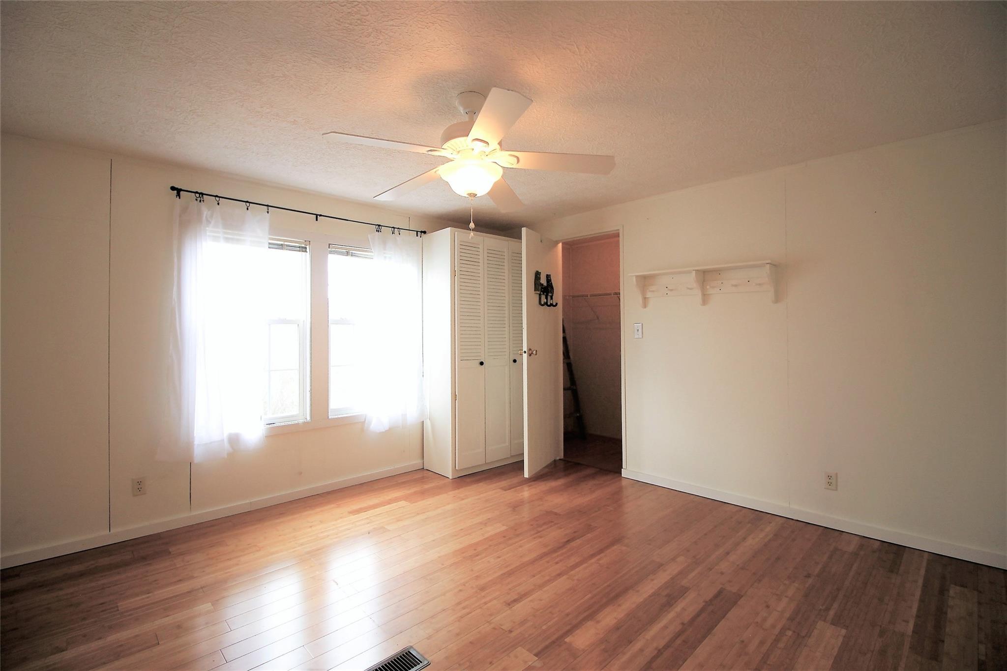 2 Whisper Street Clyde, NC 28721 - Photo 28 of 44 an empty room with wooden floor and windows