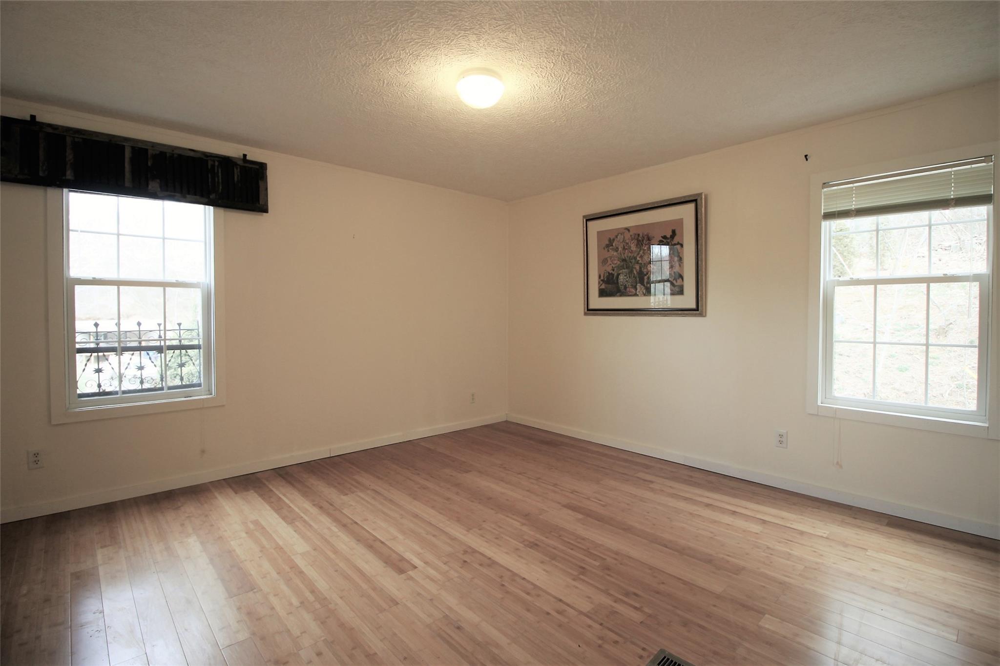 2 Whisper Street Clyde, NC 28721 - Photo 32 of 44 an empty room with wooden floor and windows