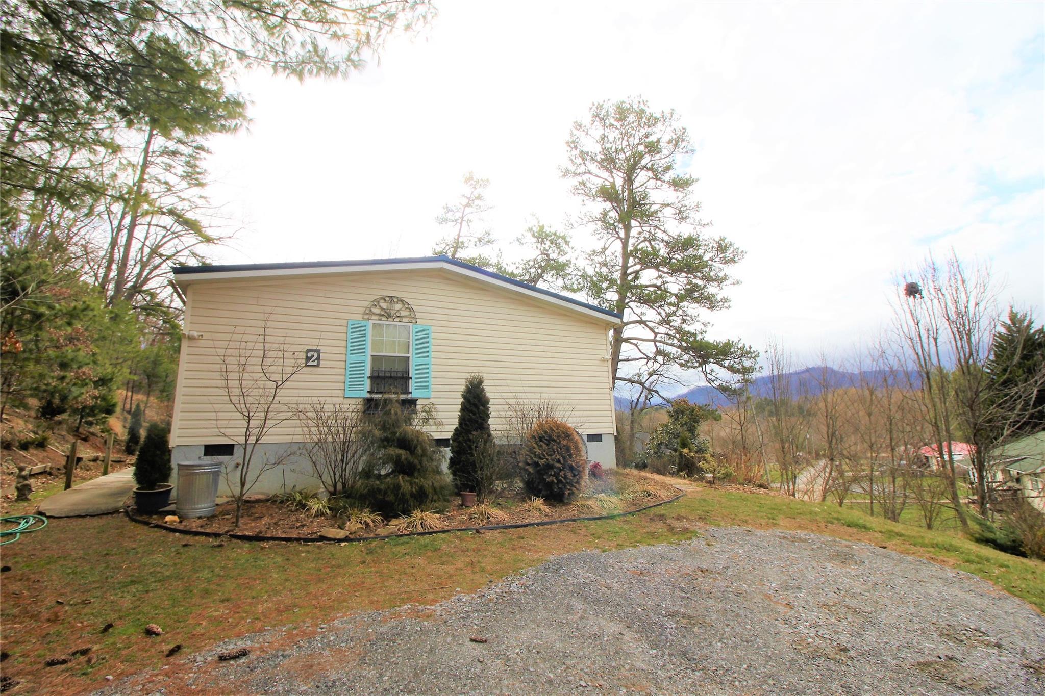 2 Whisper Street Clyde, NC 28721 - Photo 4 of 44 a view of a house with backyard and trees