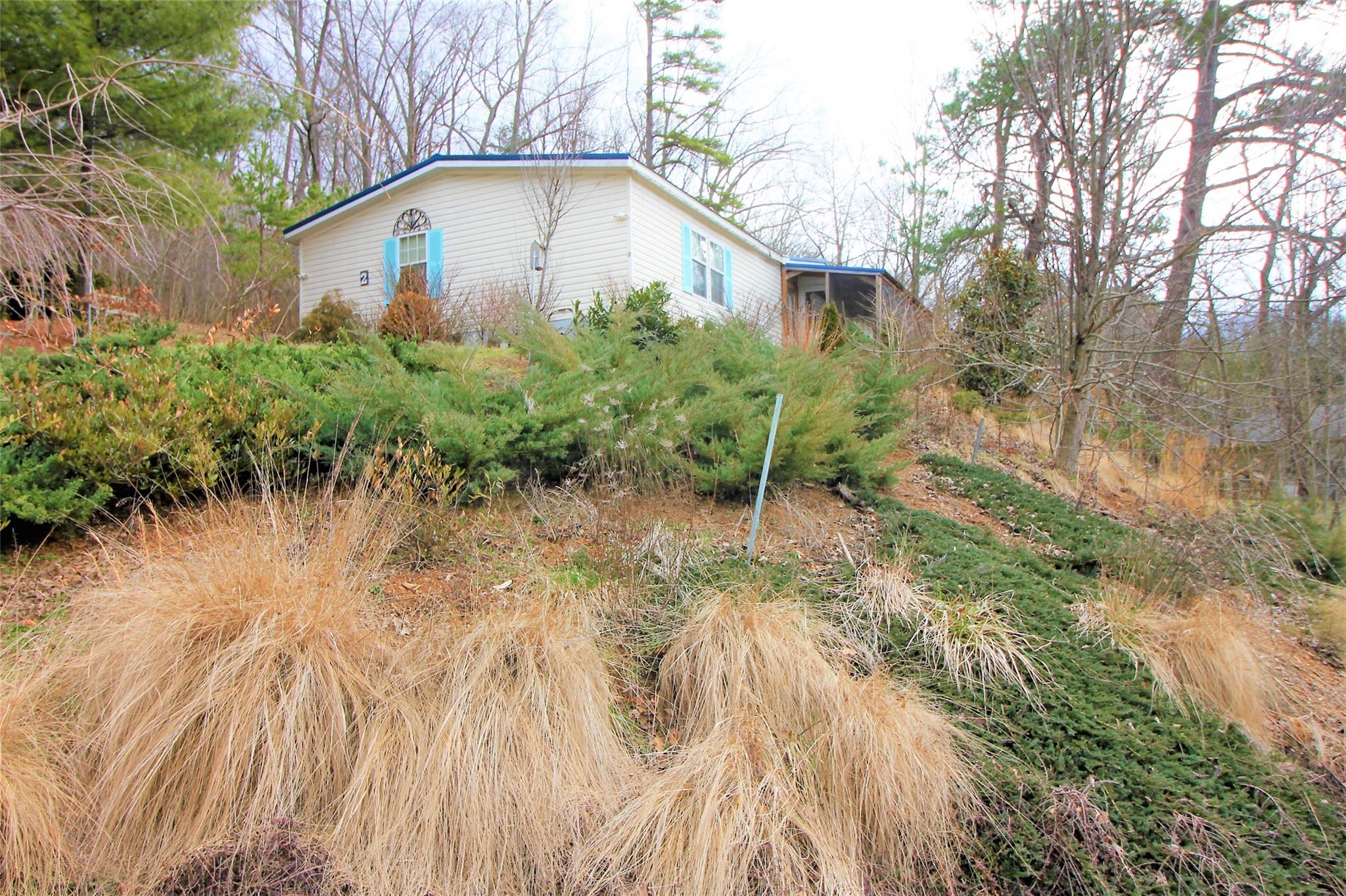 2 Whisper Street Clyde, NC 28721 - Photo 43 of 44 a front view of a house with garden