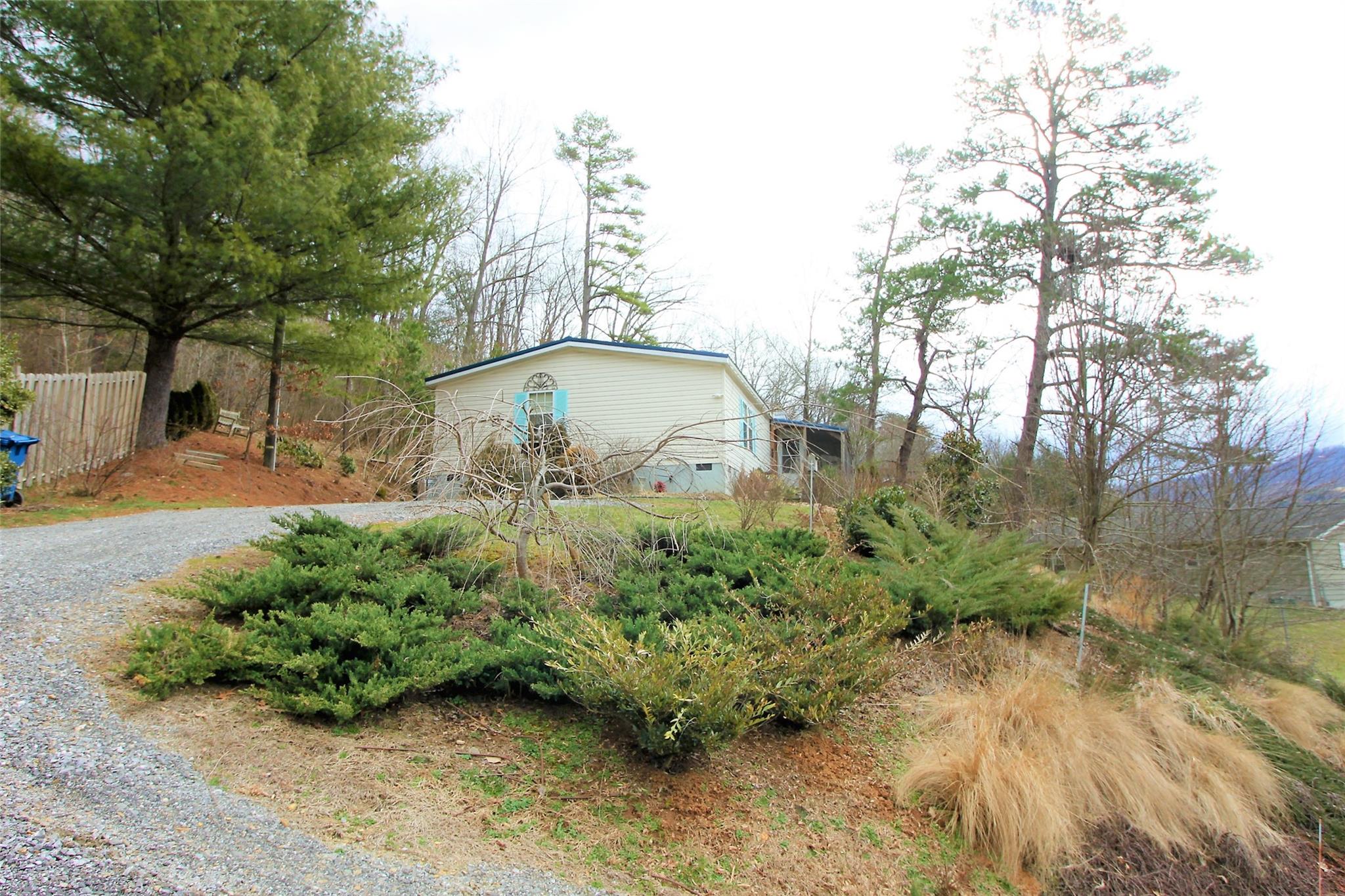 2 Whisper Street Clyde, NC 28721 - Photo 44 of 44 a view of a garden with a bench