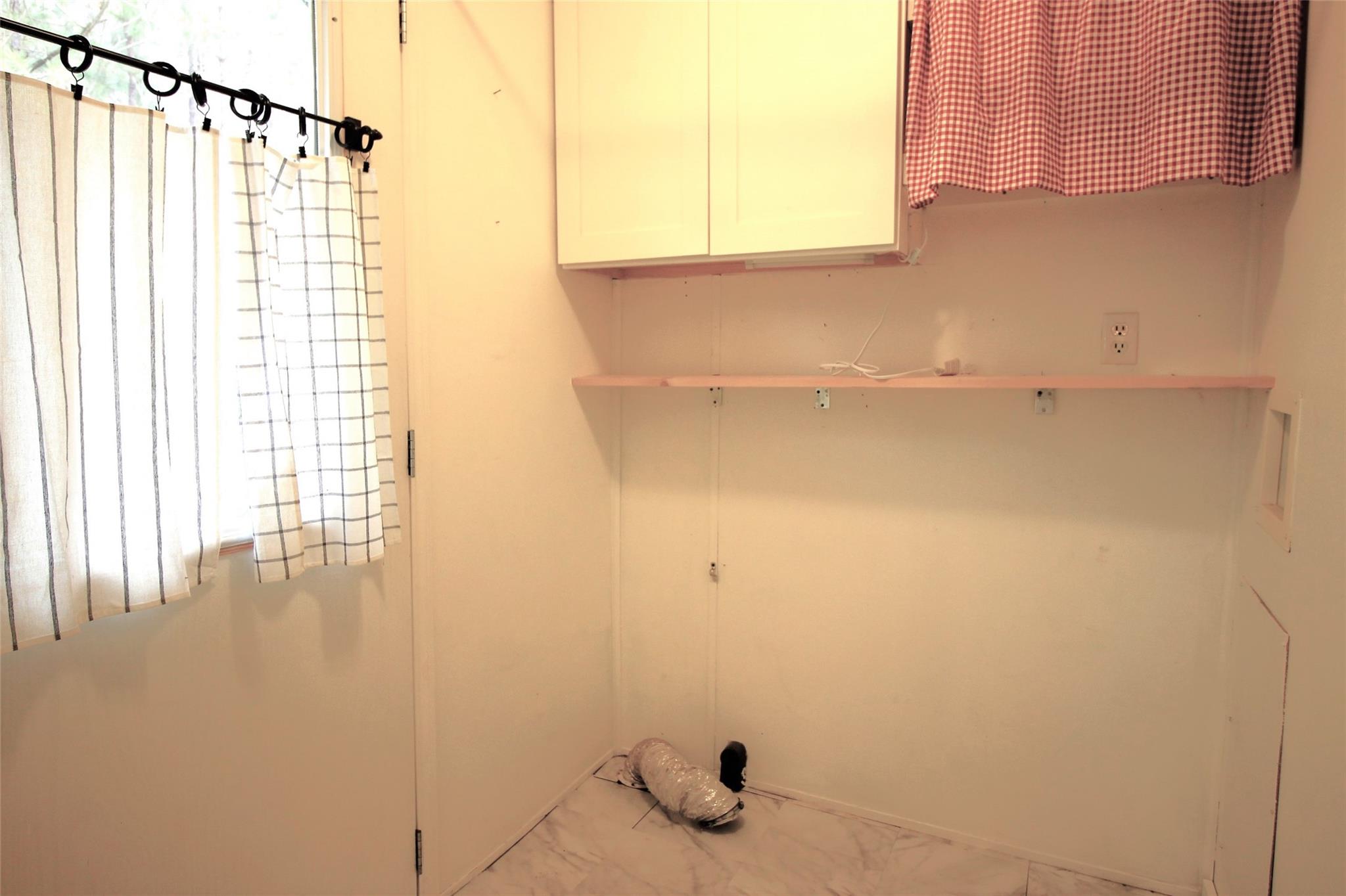 2 Whisper Street Clyde, NC 28721 - Photo 6 of 44 a bathroom with a window and a shower curtain