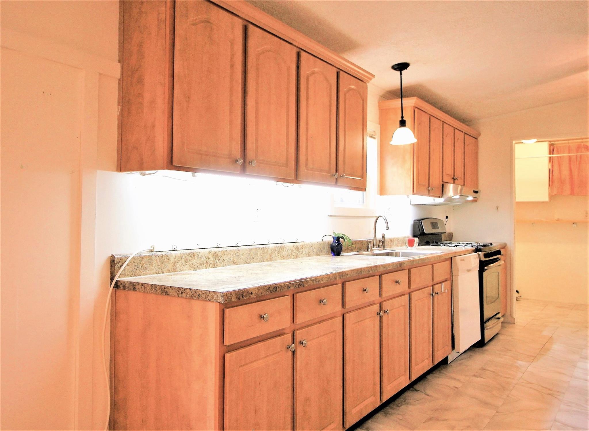2 Whisper Street Clyde, NC 28721 - Photo 8 of 44 a kitchen with stainless steel appliances granite countertop a sink and cabinets with wooden floor