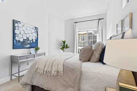 a bedroom with a large bed and a flat screen tv