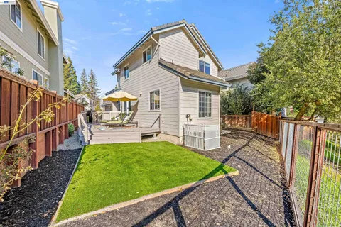 a view of a house with a small yard and potted plants