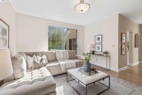 a living room with furniture a fireplace and window
