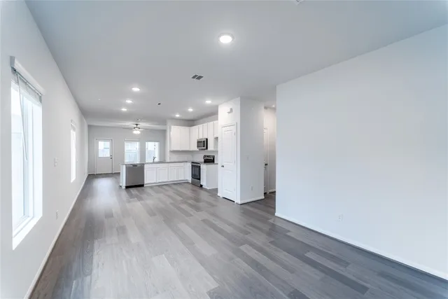 a view of an empty room with wooden floor