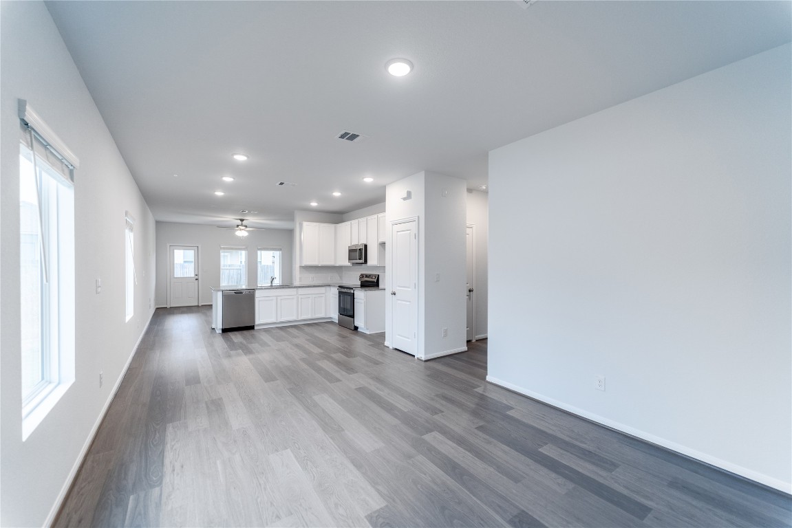 720 Barbary Coast Lane Jarrell, TX 76537 - Photo 4 of 19 a view of an empty room with wooden floor