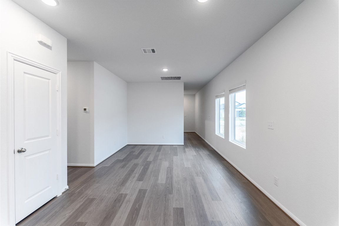 720 Barbary Coast Lane Jarrell, TX 76537 - Photo 5 of 19 an empty room with wooden floor and windows